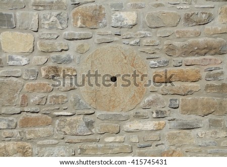 Stone wall in warm colors with grinding wheel