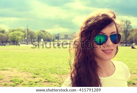 Closeup portrait of a happy young woman in Washington DC downtown on a spring summer sunny day 
