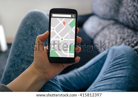 Girl holding smart phone with map gps navigation application on screen. All screen content is designed by me