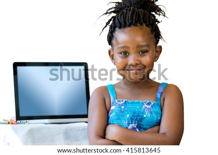 Close up portrait of little african kid standing with laptop in background.Isolated on white background.