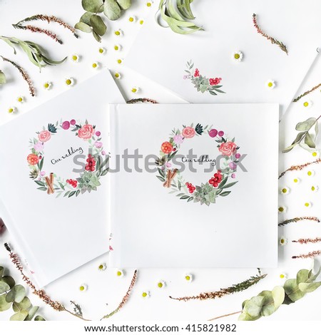wedding photo album with watercolor print, chamomile, dry and fresh branches isolated on white background. flat lay, top view