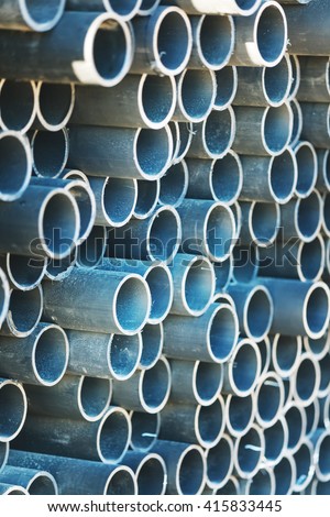 stack of rounded steel pipes with soft focus perspective