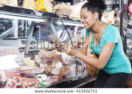 Woman Photographing Products Through Digital Tablet