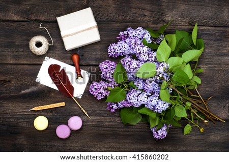 retro accessories and lilac flowers on  old wooden board background, romantic retro lifestyle