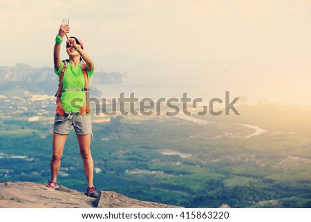 successful woman hiker enjoy the view on mountain top