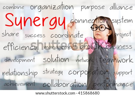 Cute little girl wearing business dress and writing synergy concept. Office background.