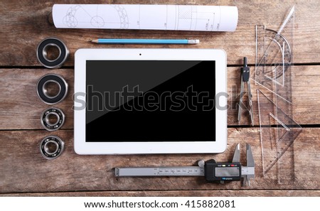 Engineering drawing with tools and tablet, top view