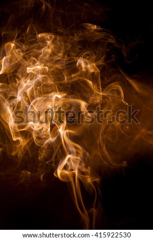 Orange smoke on a black background.