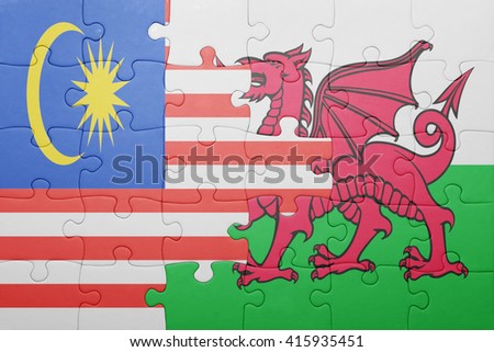 puzzle with the national flag of wales and malaysia . concept