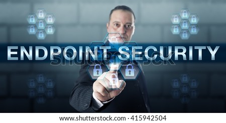 Manager is pushing ENDPOINT SECURITY on a virtual touch screen interface. Information technology and security concept for software and technology protecting corporate computing networks.