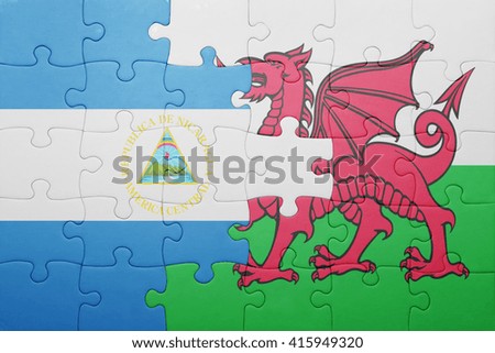 puzzle with the national flag of wales and nicaragua . concept