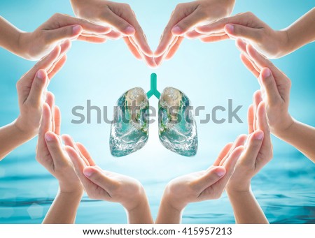 World Tuberculosis day and no tobacco day campaign, healthy lung in heart-shaped hand protection health care design logo concept. Element of this image furnished by NASA Royalty-Free Stock Photo #415957213