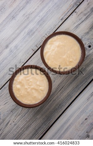 sweet curd or sweet dahi in hindi, served in earthen pot, selective focus