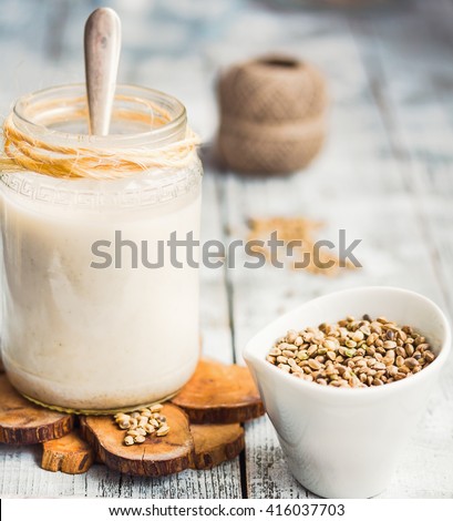 homemade vegan milk from hemp seeds in a glass jar, close-up Royalty-Free Stock Photo #416037703