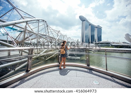 Singapore travel tourist woman on vacation  near Marina Bay Hotel. Person in dress  over singapore city background . Asian summer destination Royalty-Free Stock Photo #416064973