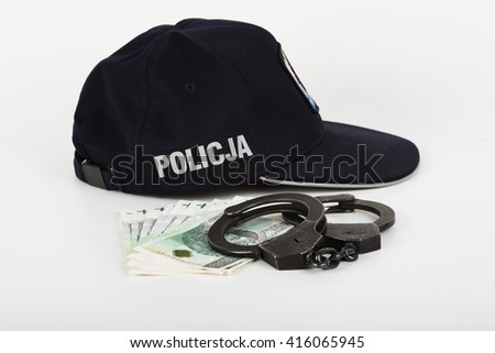 In the picture handcuffs, money and police.
