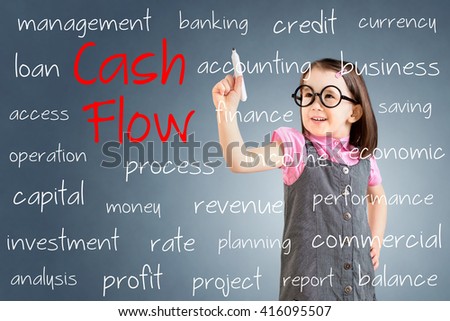 Cute little girl wearing business dress and writing cash flow concept. Blue background. 