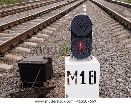 Railway track semaphore red light on, selective focus 