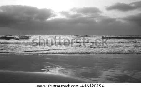 Sky sea and sand, evening time.
Black and white picture.
