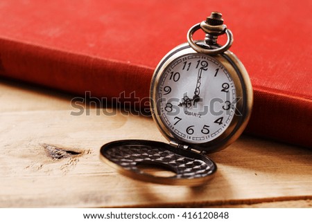 Pocket clock on books background,select focus.