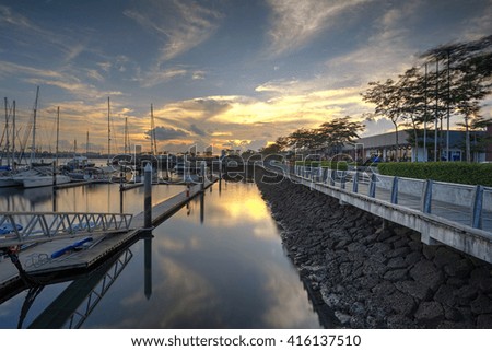 A Long Exposure picture of row of luxury sailboats reflected in water, yacht port on the bay, water transport, ocean transportation, beautiful vessel in the harbor,
