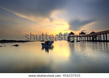 A Long Exposure Picture Of Beautiful Burning Sky With Lonely Boat During  Sunrise