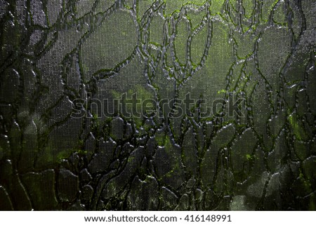 textured surface creates a very interesting pattern. Photo dark color, glass has different color shades.It can be used as the background or texture for any photo editor.