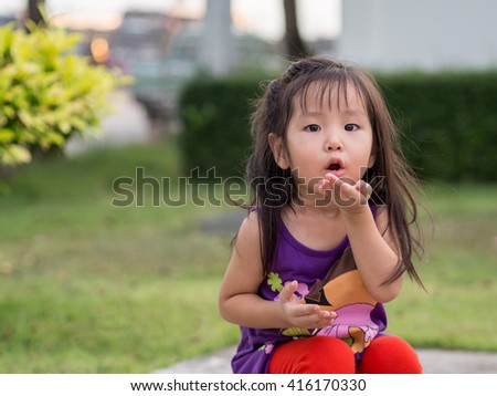 little asian girl sends kiss