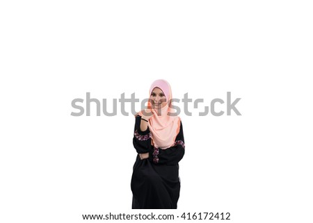 Fashion portrait of young beautiful asian muslim woman with wearing hijab smile while standing against white background. Selective focus.