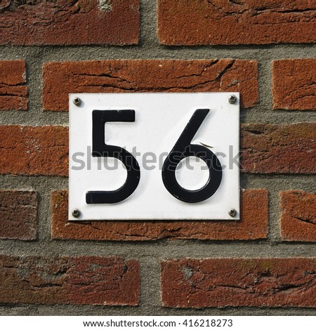 House number fifty six embossed in a metal plate