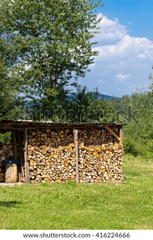 Lumberyard Stack firewood outdoors under shed