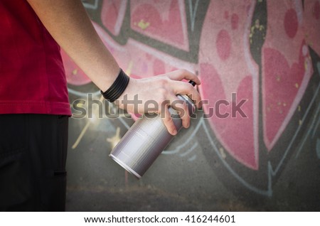 Graffiti spray can. Urban street graffiti artists  in front of a wall.