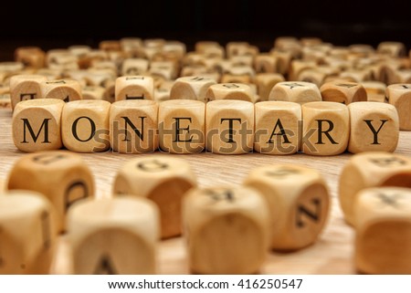 Monetary word written on wood block