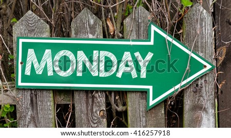 Green signboard with monday inscription. Green signboard with monday inscription on wooden fence.