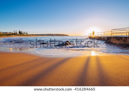 Sunrise with fisherman on rockpool at curl curl Beach, Sydney Royalty-Free Stock Photo #416284660