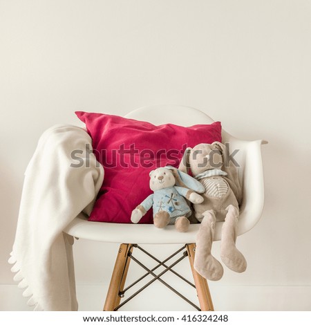 Picture of infant accessories on white modern chair