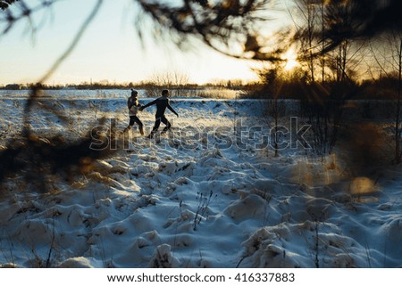 Two lovers in winter forest