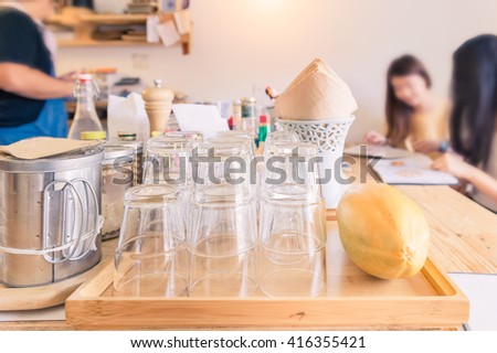 restaurant, food, eating and holiday concept - blurred image of couple with menu choosing dishes at restaurant