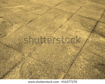 Detail of a concrete pavement with tiles vintage sepia