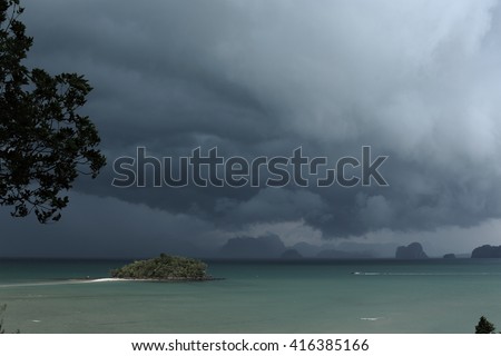 Low key picture. Poor lighting. Summer monsoon, rainstorm move into the sea. Phang nga, South of Thailand.
