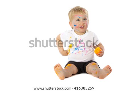 5 years old boy playing with paint, isolated on white