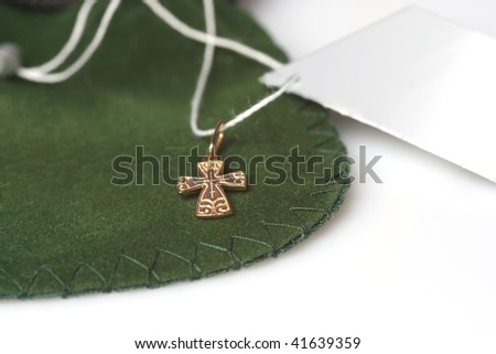 Little gold wearable jewelry orthodox cross on a white background