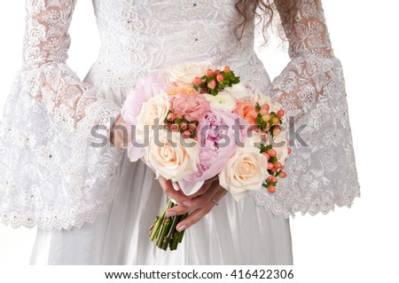 young beautiful girl in a wedding dress holding flowers isolated on white background