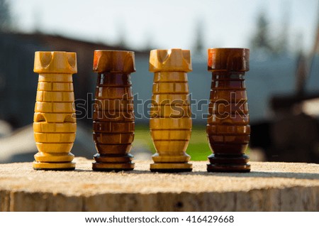 handmade chess standing on a wooden stump 