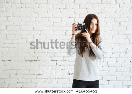 woman photographer holding a film camera in hands
