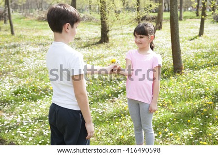 Boy giving girl a flower