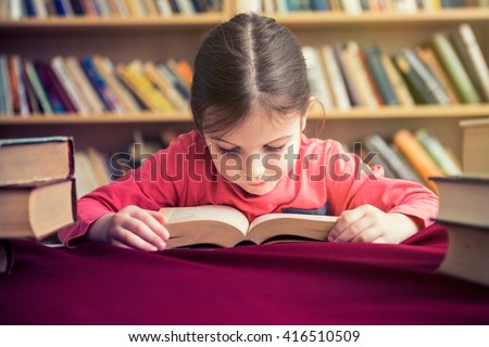 Small Girl in Old Library Reading Books Royalty-Free Stock Photo #416510509