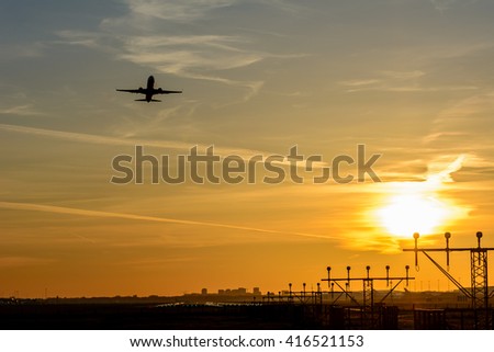 Airplane is taking off from the airport at dusk.