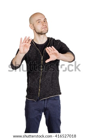 portrait young bald man  explaining something and gesturing with his hands. emotions, facial expressions, feelings, body language, signs. image on a white studio background.