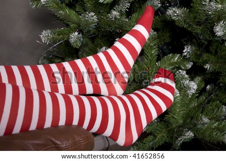 Santa's helper putting her feet up by the Christmas tree taking a break.